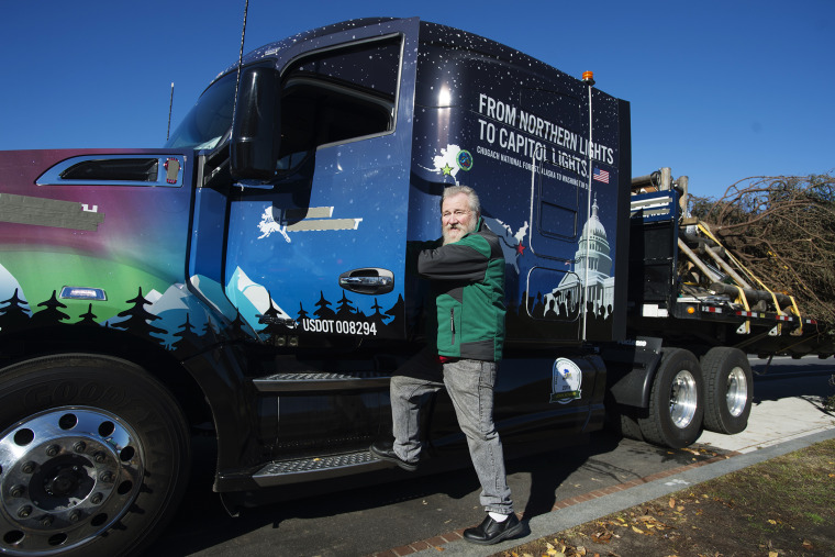 John Schank, the 2014 Alaska Truck Driver of the Year, boards the decorative truck that he drove to deliver the Capitol Christmas tree to the West Front of the US Capitol, in Washington, D.C., Nov. 20, 2015. (Photo by Michael Reynolds/EPA)