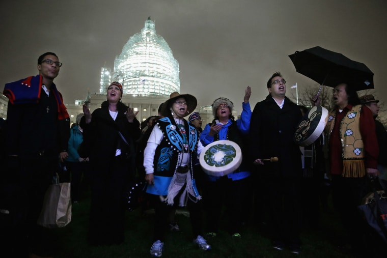 Andrea Ebona, play drums and sings in honor of the Capitol Christmas tree on the West Front of the U.S. Capitol Dec. 2, 2015 in Washington, DC. (Photo by Chip Somodevilla/Getty)