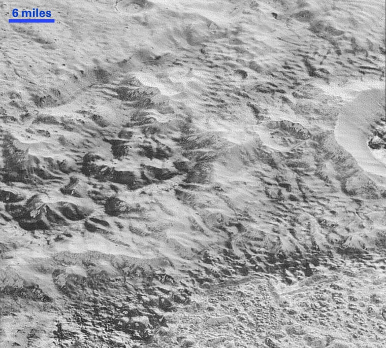 This photo of Pluto’s ‘Badlands’ shows how erosion and faulting have sculpted this portion of Pluto’s icy crust into rugged badlands topography. (Photo by NASA/JHUAPL/SwRI)