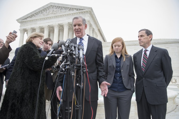 Abigail Fisher, second from right, who challenged the use of race in college admissions, listens as her lawyer Bert Rein, center, speaks with reporters outside the Supreme Court in Washington, Dec. 9, 2015. (Photo by J. Scott Applewhite/AP)
