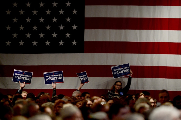 Supporters of Democratic Presidential candidate Bernie Sanders hold signs at the Jefferson Jackson Dinner at the Radisson Hotel, Nov. 29, 2015 in Manchester, N.H. (Photo by Darren McCollester/Getty)