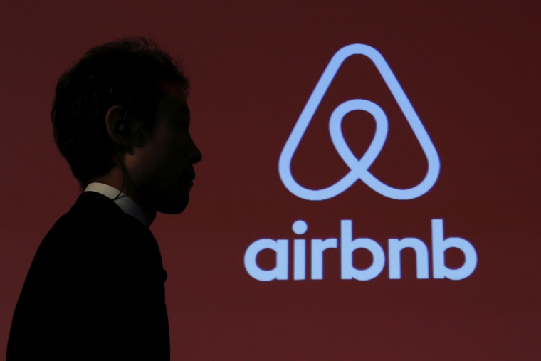 A man walks past a logo of Airbnb after a news conference in Tokyo, Japan, Nov. 26, 2015. (Photo by Yuya Shino/Reuters)