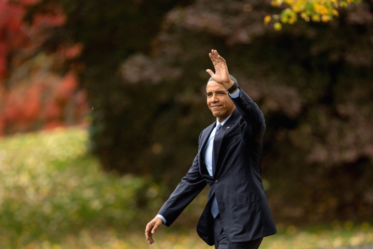 President Barack Obama waves to visitors as he walks towards Marine One on the South Lawn of the White House in Washington, D.C., Nov. 2, 2015. (Photo by Andrew Harnik/AP)
