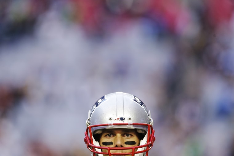 New England Patriots quarterback Tom Brady (12) watches during warm ups before the NFL Super Bowl XLIX football game against the Seattle Seahawks, Feb. 1, 2015, in Glendale, Ariz. (Photo by Patrick Semansky/AP)