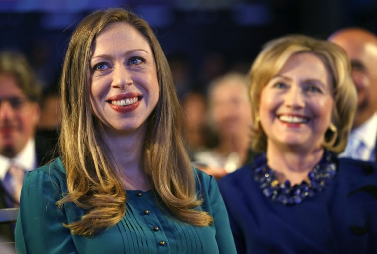 Former U.S. Secretary of State Hillary Clinton and her daughter Chelsea Clinton listen as U.S. President Barack Obama speaks at the Clinton Global Initiative in New York, Sep. 23, 2014. (Photo by Kevin Lamarque/Reuters)