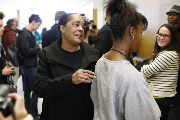 Stephanie Burke, left, and her daughter, Michelle, head for the elevator after a Denver judge set bond at $50,000 for Burke's husband, Clarence Moses-EL, during a hearing early on Dec. 22, 2015, in Denver. Co. (Photo by David Zalubowski/AP)