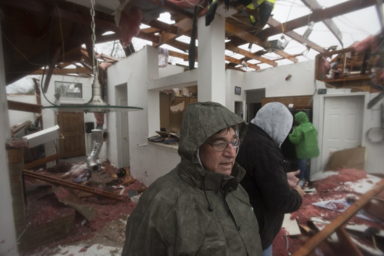 Bob Moore stands in his home in Rowlett, Texas, Dec. 27, 2015, the morning after it was struck by a tornado. At least 11 people died and dozens were injured in apparently strong tornadoes in the Dallas area this weekend. (Photo by Rex C. Curry/AP)