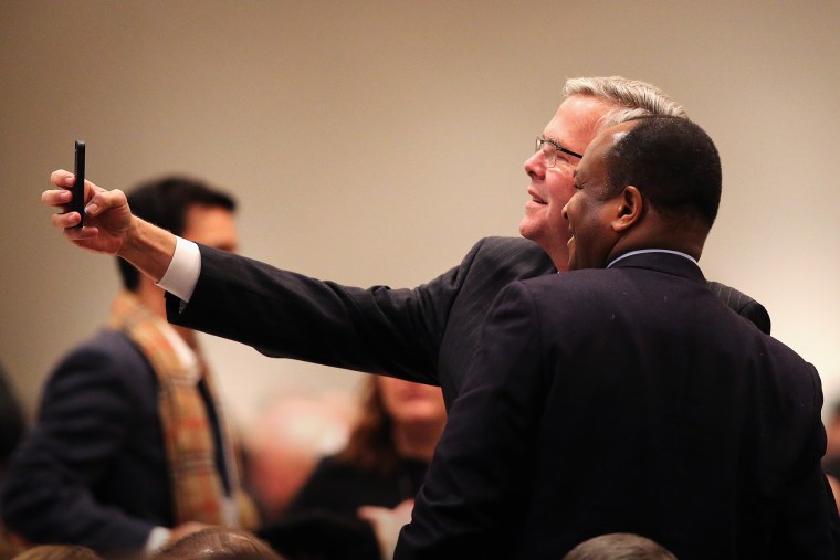 Former Florida Governor Jeb Bush takes a selfie with a guest at a luncheon on Feb. 18, 2015 in Chicago, Ill. (Photo by Scott Olson/Getty)