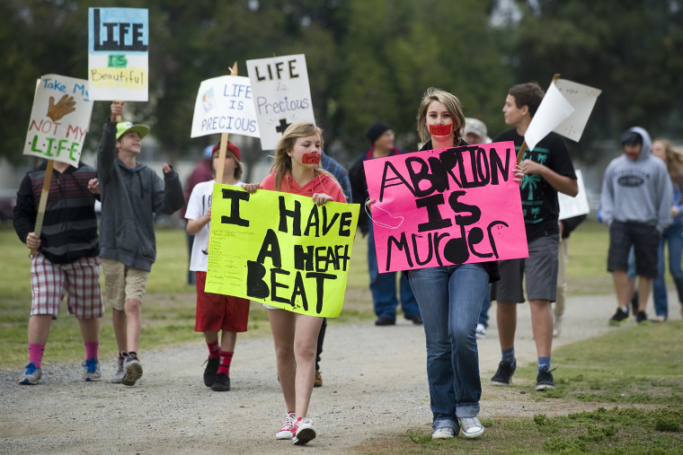 Pro-life protesters attend an annual Walk for Life, held by the Porterville Pregnancy Center Saturday, April 5, 2014 in Porterville, Calif. (Photo by Chieko Hara/The Porterville Recorder/AP)