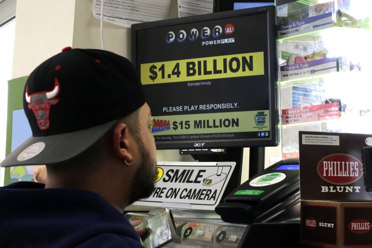 A man buys Powerball tickets at a convenience store in Lancaster, Pa., Jan. 11, 2016. (Photo by Gene J. Puskar/AP)