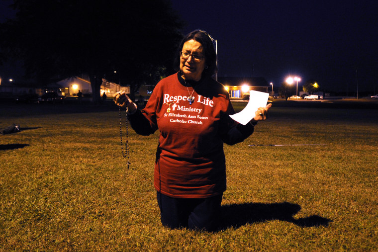 Hilda Rausini of Palm Coast, Fla., prays during a protest against the death penalty in front of the Florida State Prison near Starke, Fla., Nov. 12, 2013. (Photo by Phil Sandlin/AP)