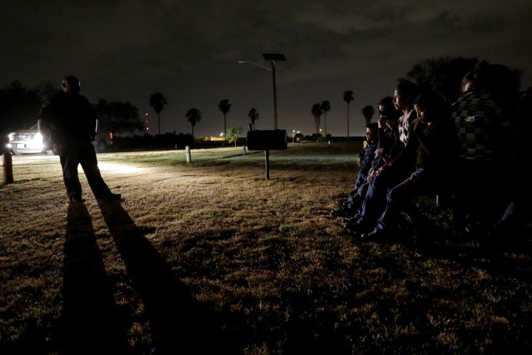 In this June 25, 2014, file photo, a group of immigrants from Honduras and El Salvador, who crossed the U.S.-Mexico border illegally, are stopped in Granjeno, Texas. (Photo by Eric Gay/AP)