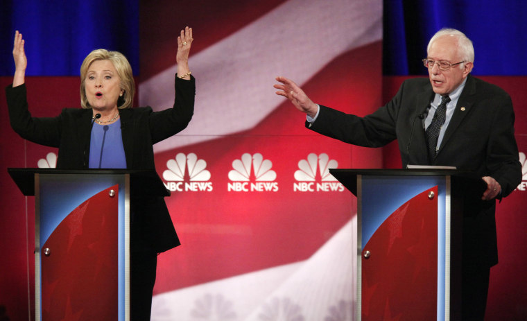 Democratic U.S. presidential candidate Hillary Clinton and rival candidate U.S. Senator Bernie Sanders speak simultaneously at the NBC News - YouTube Democratic presidential candidates debate, Jan. 17, 2016. (Photo by Randall Hill/Reuters)