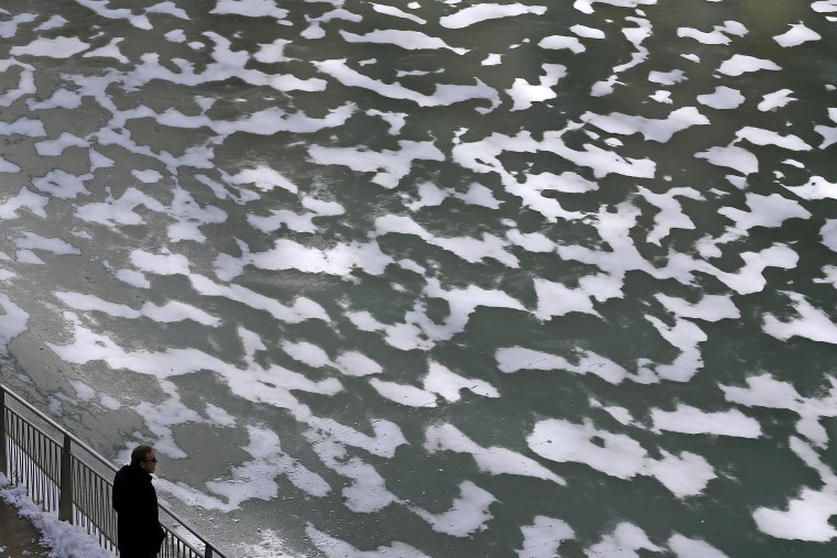 A man looks out over the frozen Chicago River in Chicago, Ill., on Jan. 14, 2016. (Photo by Jim Young/Reuters)