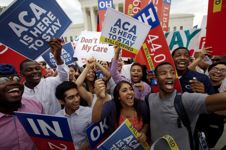 In this June 25, 2015 file photo, students cheer outside of the Supreme Court in Washington, celebrating the Supreme Court decision that the ACA may provide nationwide tax subsidies. (Photo by Jacquelyn Martin/AP)