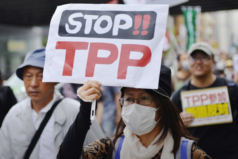 A woman protests against the Trans-Pacific Strategic Economic Partnership Agreement, or TPP, during a demonstration at Ginza, Chuo, Tokyo, Japan on May 25, 2013. (Photo by Koichiro Suzuki/AFLO/ZUMA)