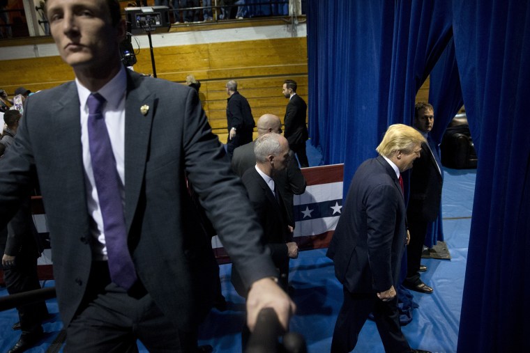 Republican presidential candidate Donald Trump, right, smiles as leaves the gym after a rally, Jan. 12, 2016, in Cedar Falls, Iowa. (Photo by Jae C. Hong/AP)