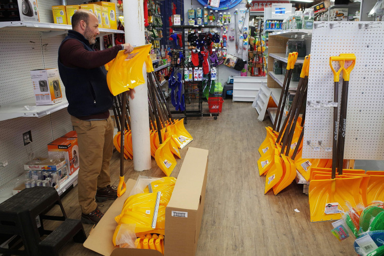 A worker in a hardware store assembles snow shovels on Jan. 21, 2016 ahead of an expected blizzard. (Photo by Mandel Ngan/AFP/Getty)