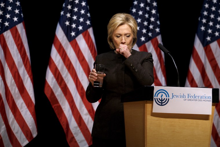 Democratic presidential candidate Hillary Clinton holds up a glass of water as she struggles to contain a coughing fit at the Jewish Federation of Greater Des Moines, Iowa, Jan. 25, 2016. (Photo by Rick Wilking/Reuters)