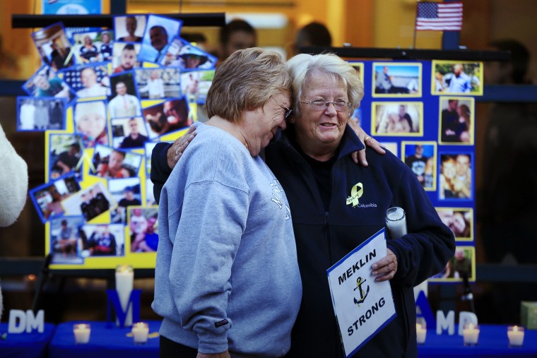 Deborah Dyer, right, is hugged by Judy Marzolf at vigil held at Maine Maritime Academy for the missing crew members of the U.S. container ship El Faro, Oct. 6, 2015, in Castine, Maine. (Photo by Robert F. Bukaty/AP)