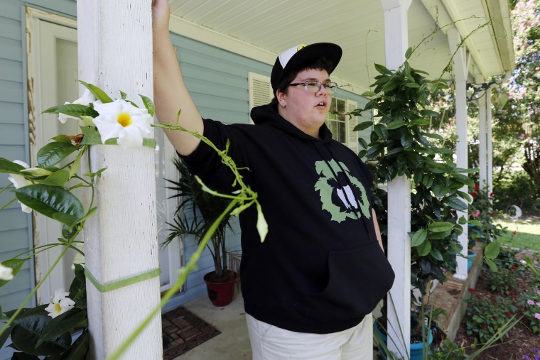 This Aug. 25, 2015 photo shows Gavin Grimm leaning on a post on his front porch during an interview at his home in Gloucester, Va. (Photo by Steve Helber/AP)