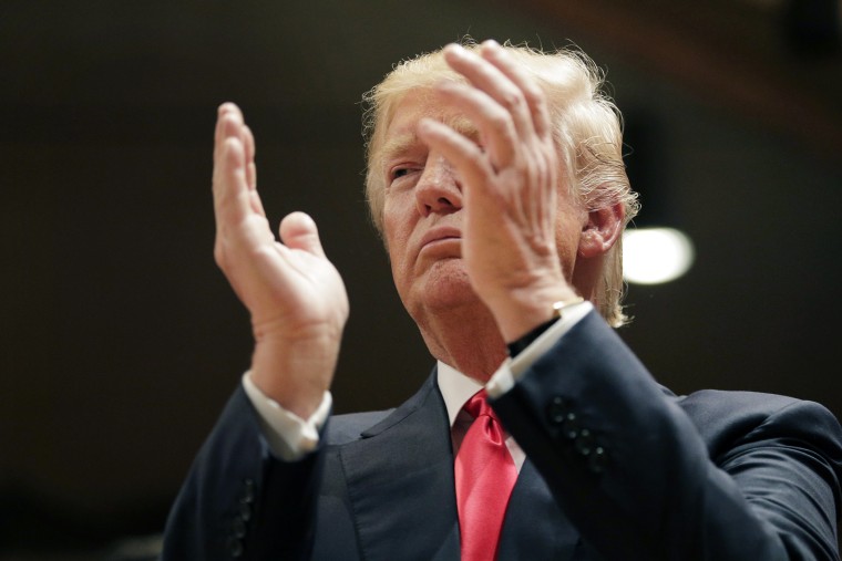 Republican presidential candidate Donald Trump applauds while visiting Saint Francis of Assisi Church, a caucus site on Feb. 1, 2016, in West Des Moines, Iowa. (Photo by Jae C. Hong/AP)