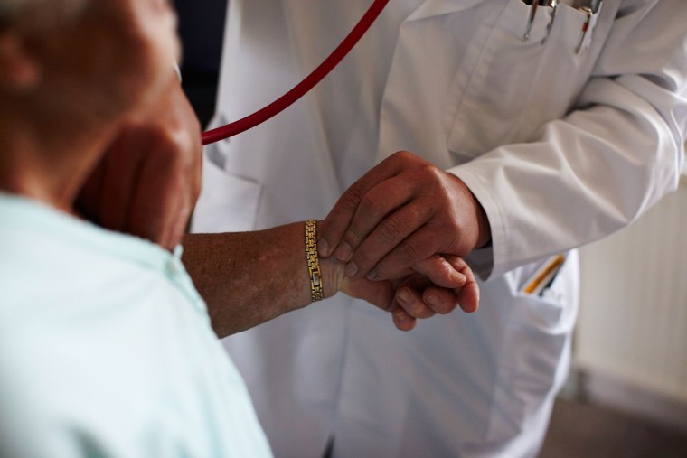 A doctor measures the blood pressure of a patient. (Photo by Carsten Koall/Getty)