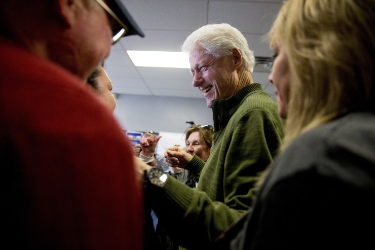 Former President Bill Clinton greets supporters at a campaign office for Democratic presidential candidate Hillary Clinton in Ankeny, Iowa, Feb. 1, 2016. (Photo by Andrew Harnik/AP)
