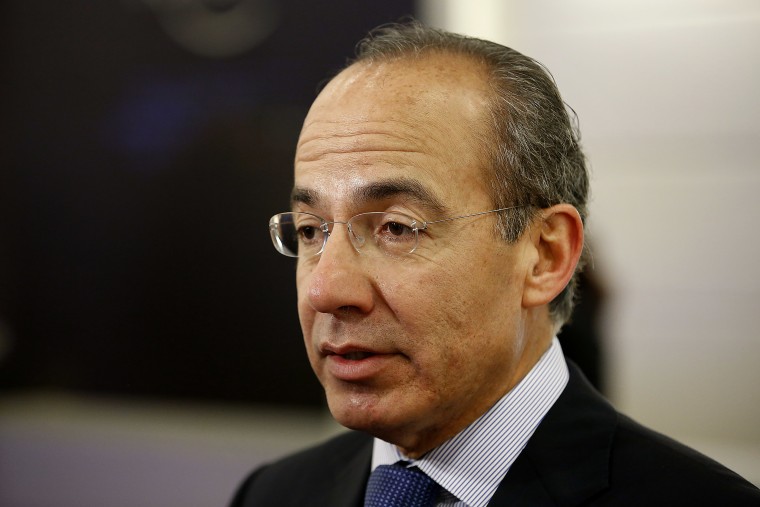Felipe Calderon, former president of Mexico, speaks to an attendee in the halls on the opening day of the World Economic Forum (WEF) in Davos, Switzerland, Jan. 23, 2013. (Photo by Jason Alden/Bloomberg/Getty)