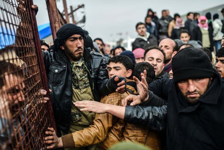 Refugees push each other as they wait for tents as Syrians fleeing the northern embattled city of Aleppo wait on Feb. 6, 2016 in Bab al-Salama, near the city of Azaz, northern Syria, near the Turkish border crossing. (Photo by Bulent Kilic/AFP/Getty)