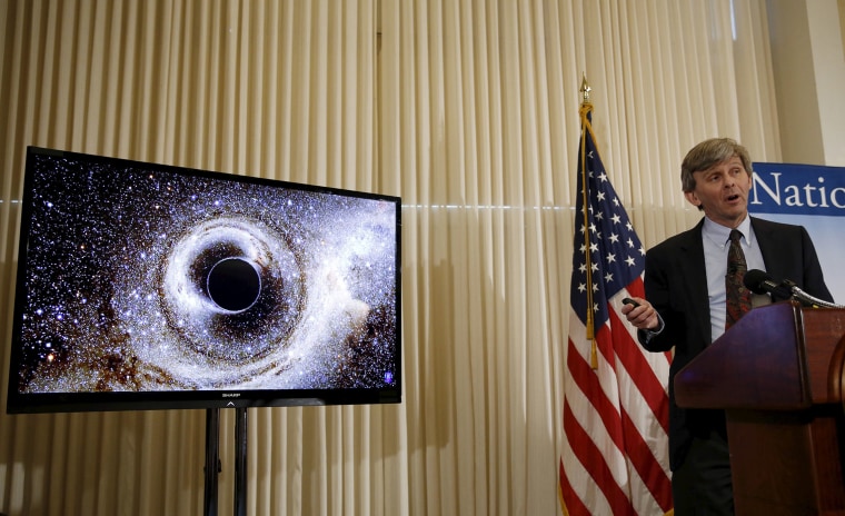 Dr. David Reitze, Executive Director of the Caltech LIGO Laboratory, shows the merging of two black holes , discussing the detection of gravitational waves, as hypothesized by Albert Einstein, Feb. 11, 2016. (Photo by Gary Cameron/Reuters)