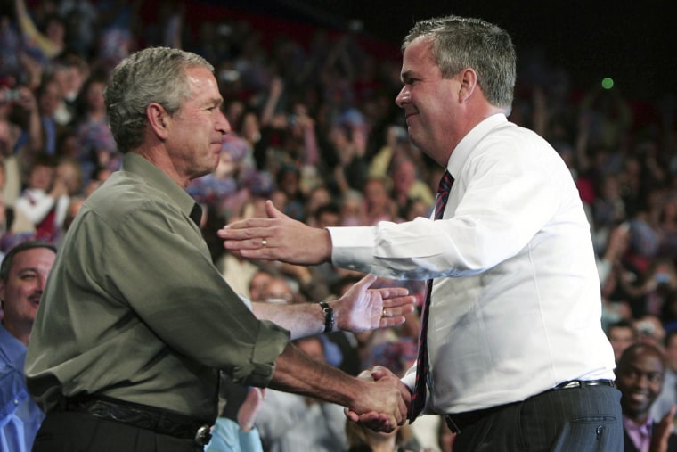 Former president George W. Bush greets his brother, former Florida Governor Jeb Bush, at a Republican Party congressional mid-term election campaign rally in Pensacola, Fla, Nov. 6, 2006. (Photo by Jason Reed/Reuters)