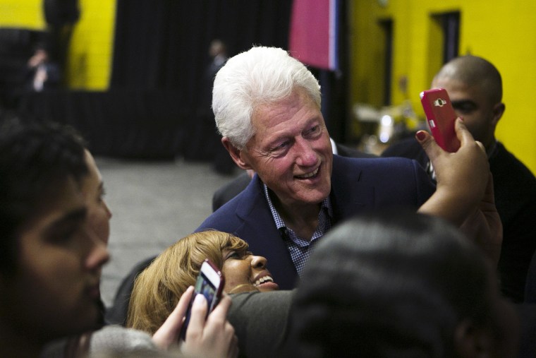 Former President Bill Clinton smiles for a selfie with a supporter of his wife following a speech at Whitehaven High School, Feb. 11, 2016, in Memphis, Tenn. (Photo by Yalonda M. James/The Commercial Appeal/AP)
