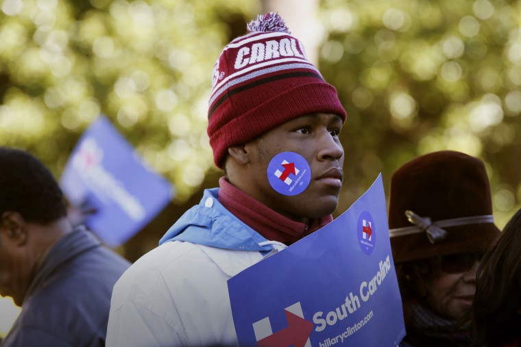 An attendee decked in Hillary Clinton campaign merchandise listens during an event on the front steps of the State House in Columbia, S.C., Jan. 18, 2016. (Photo by Patrick T. Fallon/Bloomberg/Getty)