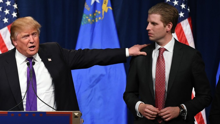 Eric Trump looks at his father, Republican presidential candidate Donald Trump, during a caucus night watch party at the Treasure Island Hotel & Casino on Feb. 23, 2016 in Las Vegas, Nev. (Photo by Ethan Miller/Getty)