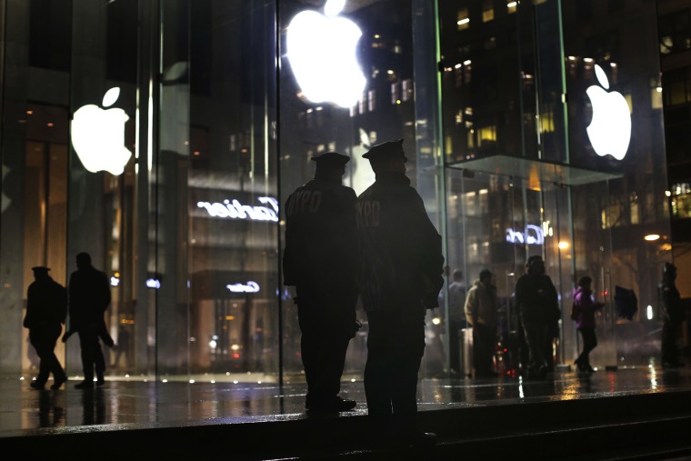 New York police officers stand outside the Apple Store on Fifth Avenue while monitoring a demonstration, Feb. 23, 2016, in New York. (Photo by Julie Jacobson/AP)