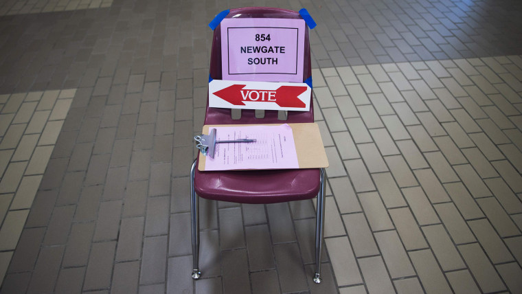 Signs are seen on a chair to assist voters at Centreville High School in Centreville, Va., March 1, 2016, during the Super Tuesday primary voting. (Photo by Paul J. Richards/AFP/Getty)