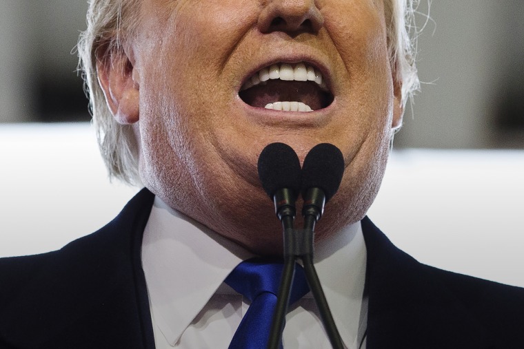 Republican presidential candidate Donald Trump bares his teeth during a campaign stop at the Signature Flight Hangar at Port-Columbus International Airport, March 1, 2016, in Columbus, Ohio. (Photo by John Minchillo/AP)