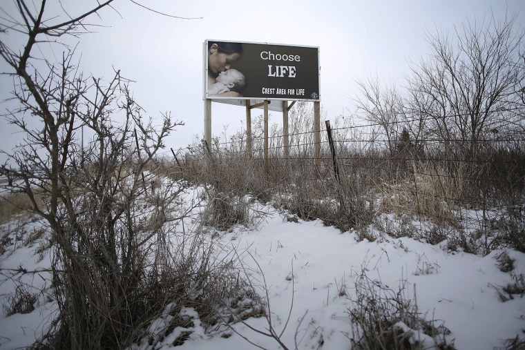 A \"Chose Life\" advertisement is displayed along a snow covered U.S. Highway 34 on Jan. 22, 2016 in Thayer, Iowa. (Photo by Joshua Lott/Getty)