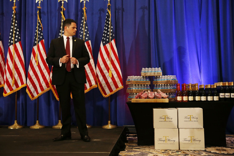 A security agent stands near a display Donald Trump brands before a press conference at the Trump National Golf Club Jupiter on March 8, 2016 in Jupiter, Fla. (Photo by Joe Raedle/Getty)