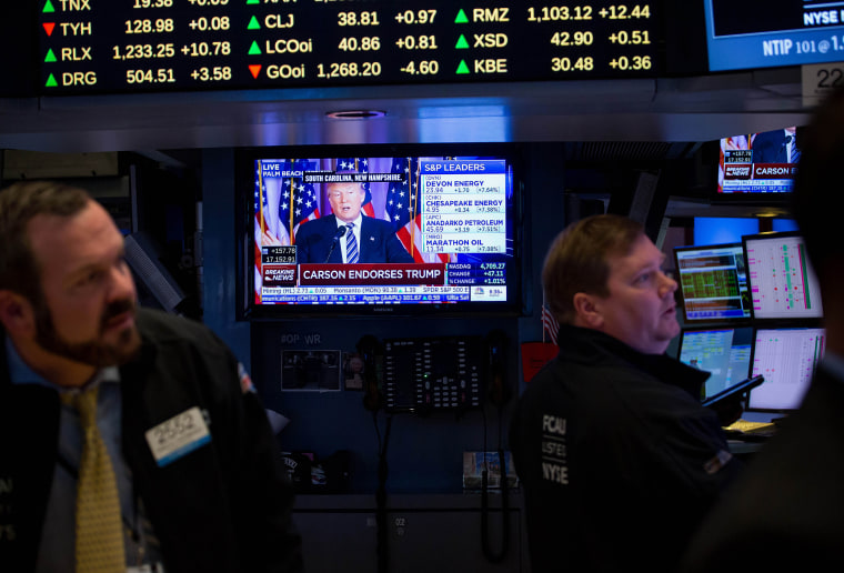 Donald Trump is seen speaking on a monitor as traders work on the floor of the New York Stock Exchange (NYSE) in New York, U.S., March 11, 2016. (Photo by Michael Nagle/Bloomberg/Getty)