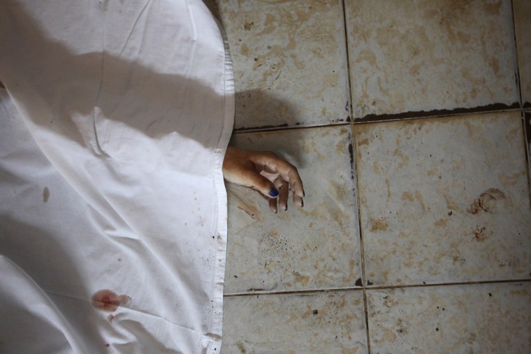 The hand of a person killed is seen after an attack in Grand Bassam, Ivory Coast, March 13, 2016. (Photo by Joe Penney/Reuters)