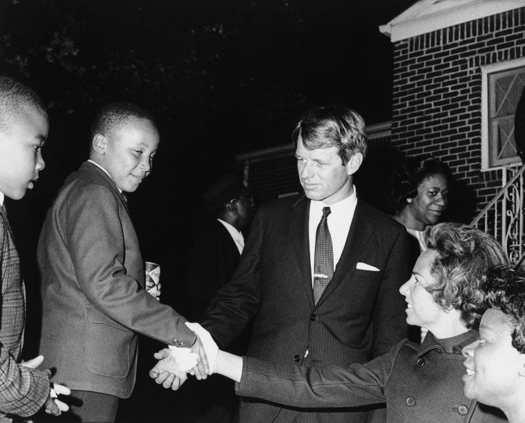 Ethel Kennedy shakes hands with Martin Luther King III after she and her husband Robert F. Kennedy, center, visited his mother Coretta Scott King at her Atlanta home, April 8, 1968. Another of the slain civil rights leader’s sons, Dexter, is at left. (AP Photo)