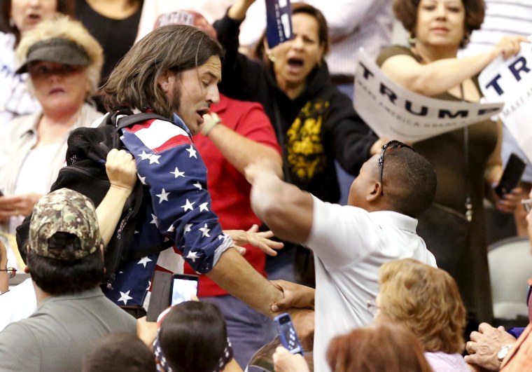 A member of the audience (R) throws a punch at a protester as Republican Presidential candidate Donald Trump speaks during a campaign event in Tucson, Ariz., March 19, 2016. (Photo by Sam Mircovich/Reuters)