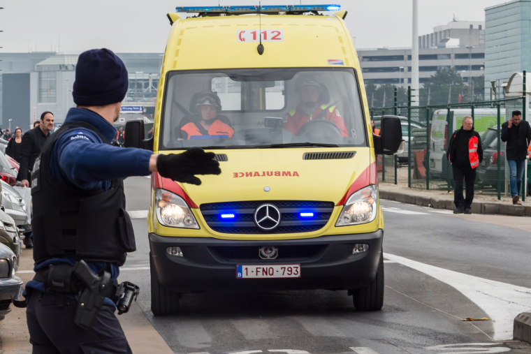 Ambulances arrive to the scene at Brussels airport, after explosions rocked the facility in Brussels, Belgium, March 22, 2016. (Photo by Geert Vanden Wijngaert/AP)