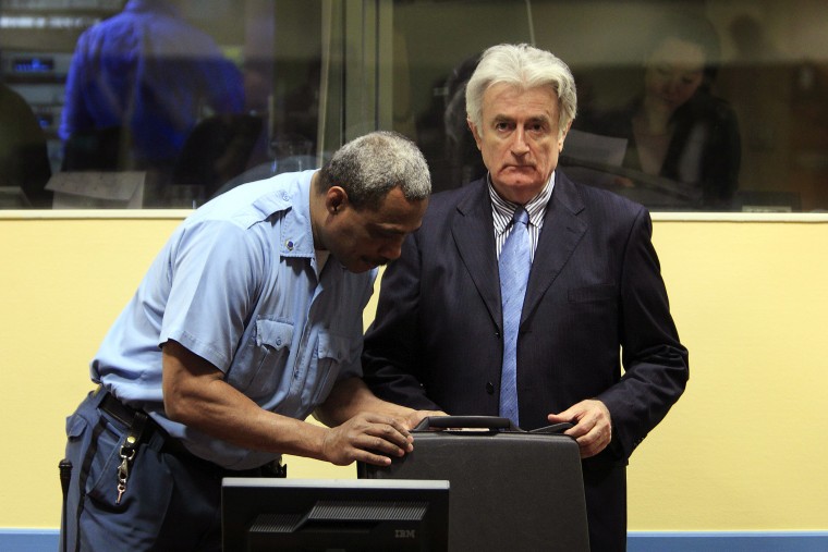 A security guard opens the suitcase of former Bosnian Serb leader Radovan Karadzic in the Hague at the International Criminal Tribunal for the former Yugoslavia facing indictment for alleged war crimes, March 3, 2009. (Photo by Jerry Lampen/AFP/Getty)