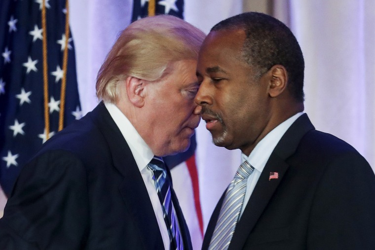 Republican U.S. presidential candidate Donald Trump walks behind former Republican presidential candidate Ben Carson after receiving Carson's endorsement at a campaign event in Palm Beach, Fl., March 11, 2016. (Photo by Carlo Allegri/Reuters)