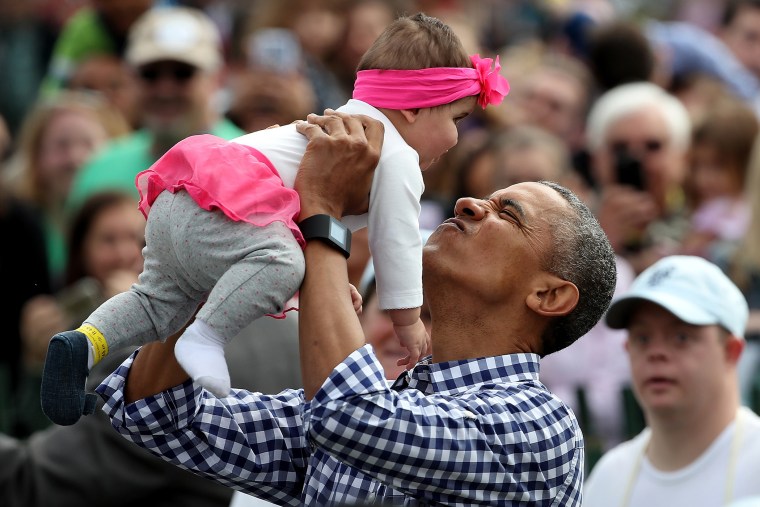 President Barack Obama lifts Stella Munoz into the air while greeting guests on the South Lawn of the White House during the annual White House Easter Egg Roll March 28, 2016 in Washington, D.C. (Photo by Win McNamee/Getty)