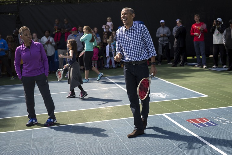 President Barack Obama laughs while playing tennis with children during the annual White House Easter Egg Roll on the South Lawn of the White House March 28, 2016 in Washington, D.C. (Photo by Drew Angerer/Getty)