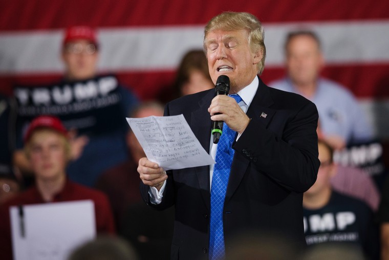 During a campaign rally Republican presidential candidate Donald Trump reads a statement made by Michelle Fields, on March 29, 2016 in Janesville, Wis. (Photo by Scott Olson/Getty)